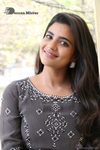Heroine Aishwarya Rajesh poses for pictures in a brown dress