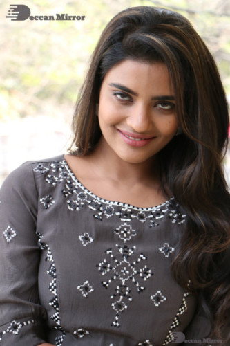 Heroine Aishwarya Rajesh poses for pictures in a brown dress