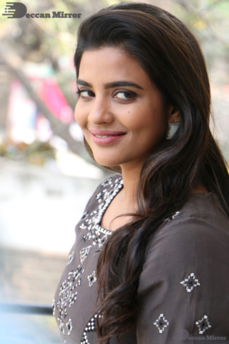 Heroine Aishwarya Rajesh poses for pictures in a brown dress