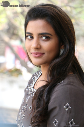 Heroine Aishwarya Rajesh poses for pictures in a brown dress