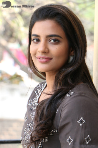 Heroine Aishwarya Rajesh poses for pictures in a brown dress