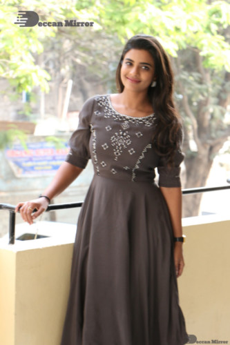 Heroine Aishwarya Rajesh poses for pictures in a brown dress