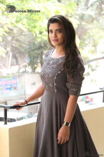 Heroine Aishwarya Rajesh poses for pictures in a brown dress