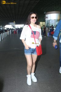 actress ameesha patel cute in a white top and blue denim shorts