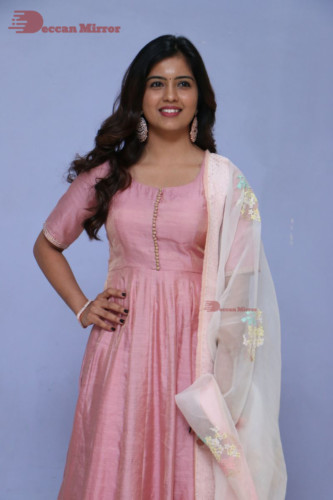 Actress Amritha Aiyer poses for a photoshoot in a pink salwar dress