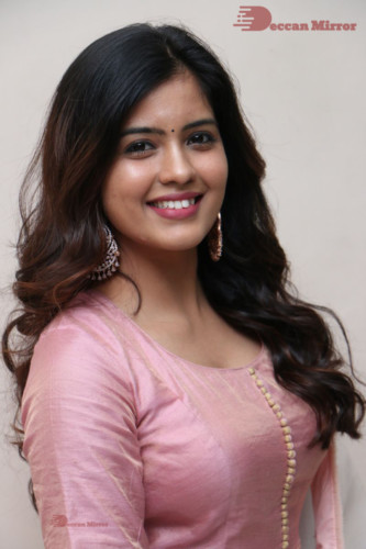 Actress Amritha Aiyer poses for a photoshoot in a pink salwar dress