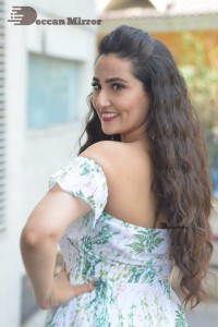 Television Anchor Manjusha poses in a white floral dress