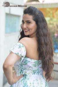 Television Anchor Manjusha poses in a white floral dress