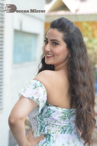 Television Anchor Manjusha poses in a white floral dress