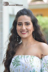 Television Anchor Manjusha poses in a white floral dress