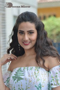 Television Anchor Manjusha poses in a white floral dress