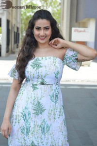 Television Anchor Manjusha poses in a white floral dress