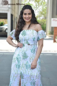 Television Anchor Manjusha poses in a white floral dress