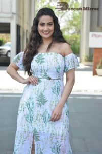 Television Anchor Manjusha poses in a white floral dress