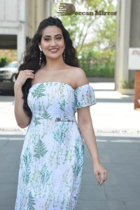 Television Anchor Manjusha poses in a white floral dress