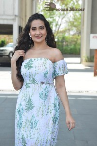 Television Anchor Manjusha poses in a white floral dress