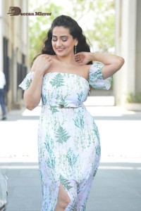 Television Anchor Manjusha poses in a white floral dress
