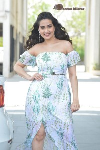 Television Anchor Manjusha poses in a white floral dress