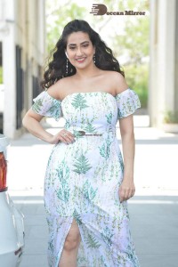 Television Anchor Manjusha poses in a white floral dress