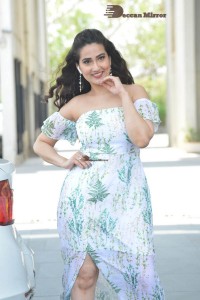 Television Anchor Manjusha poses in a white floral dress