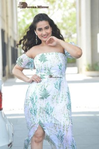 Television Anchor Manjusha poses in a white floral dress
