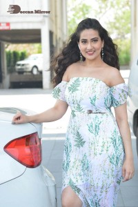 Television Anchor Manjusha poses in a white floral dress