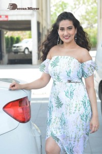 Television Anchor Manjusha poses in a white floral dress