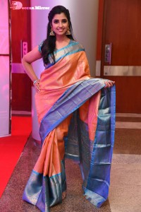 Anchor Syamala in a orange saree attending a function