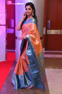 Anchor Syamala in a orange saree attending a function