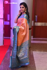 Anchor Syamala in a orange saree attending a function
