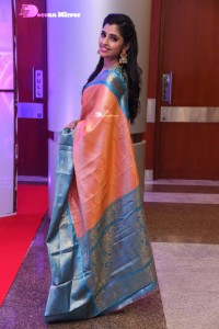 Anchor Syamala in a orange saree attending a function