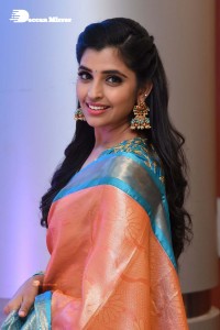 Anchor Syamala in a orange saree attending a function