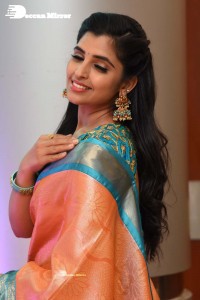 Anchor Syamala in a orange saree attending a function