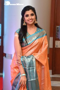 Anchor Syamala in a orange saree attending a function