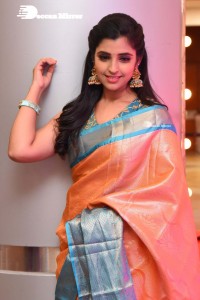 Anchor Syamala in a orange saree attending a function
