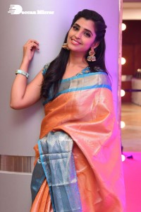 Anchor Syamala in a orange saree attending a function