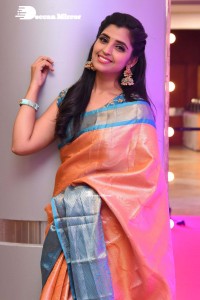 Anchor Syamala in a orange saree attending a function