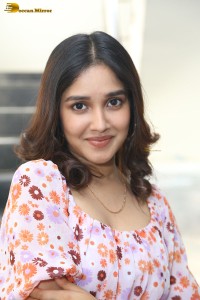 actress anikha surendran in a pink and white floral dress