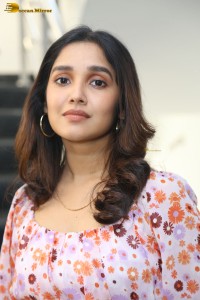 actress anikha surendran in a pink and white floral dress