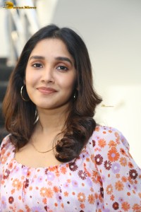 actress anikha surendran in a pink and white floral dress