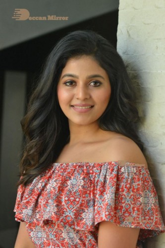 Telugu and Tamil Actress Anjali poses for pictures in Orange Off Shoulder Top and Jeans