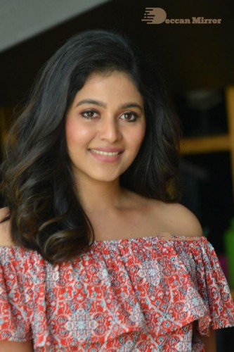 Telugu and Tamil Actress Anjali poses for pictures in Orange Off Shoulder Top and Jeans