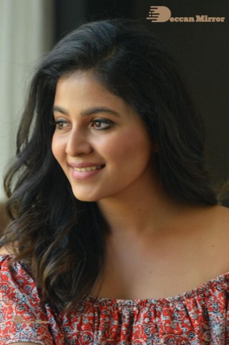 Telugu and Tamil Actress Anjali poses for pictures in Orange Off Shoulder Top and Jeans