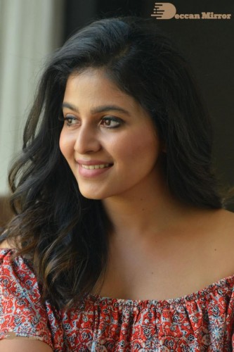 Telugu and Tamil Actress Anjali poses for pictures in Orange Off Shoulder Top and Jeans