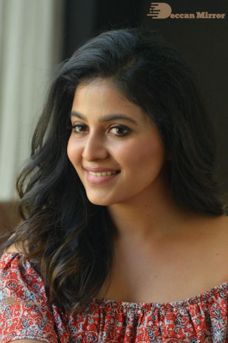 Telugu and Tamil Actress Anjali poses for pictures in Orange Off Shoulder Top and Jeans