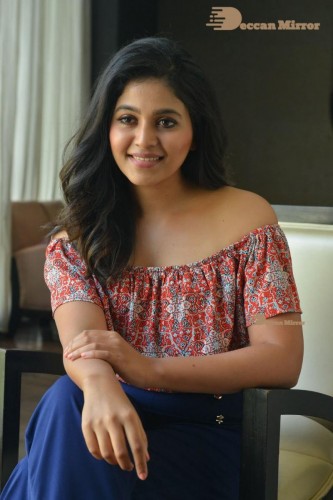 Telugu and Tamil Actress Anjali poses for pictures in Orange Off Shoulder Top and Jeans