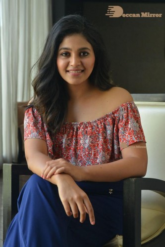 Telugu and Tamil Actress Anjali poses for pictures in Orange Off Shoulder Top and Jeans