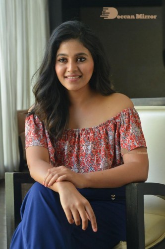 Telugu and Tamil Actress Anjali poses for pictures in Orange Off Shoulder Top and Jeans