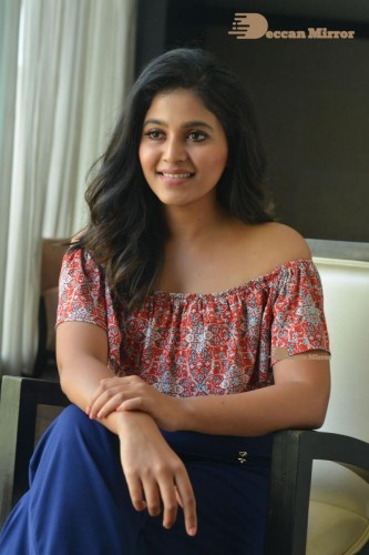 Telugu and Tamil Actress Anjali poses for pictures in Orange Off Shoulder Top and Jeans