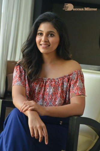 Telugu and Tamil Actress Anjali poses for pictures in Orange Off Shoulder Top and Jeans